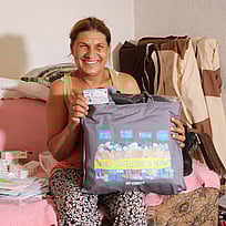 En kvinna som tidigare varit statslös visar upp sitt nya ID-kort.