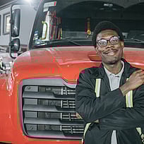 En man framför en röd bil.