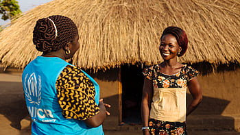 Två kvinnor samtalar och skrattar.